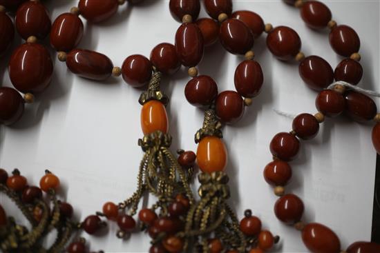 A Persian gilt metal and graduated amber bead tassel drop necklace, 180cm incl. tassel.